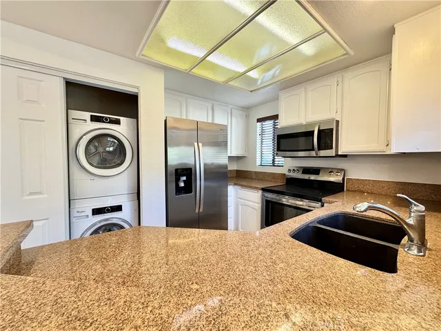 a kitchen with a refrigerator and a stove top oven