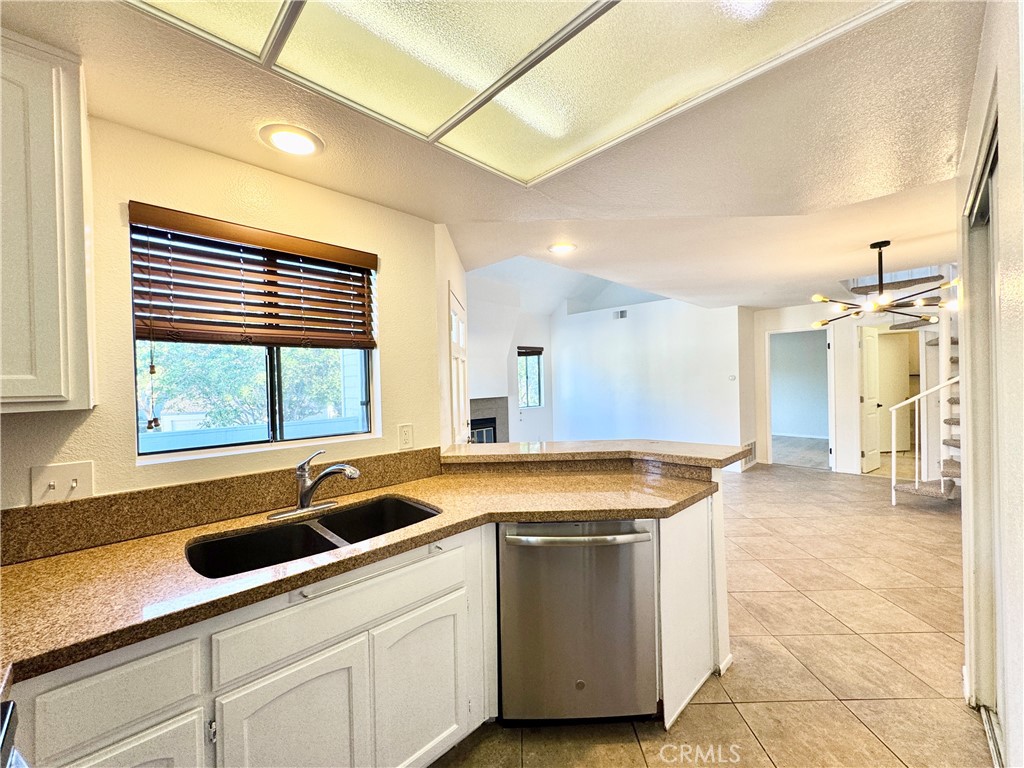 109 Fallingstar, Unit 61 Irvine, CA 92614 - Photo 18 of 34 a kitchen with a sink and large window
