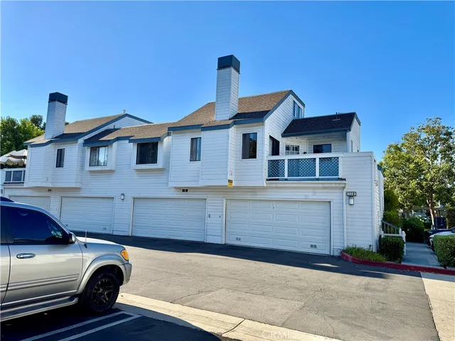 a front view of a house with parking space