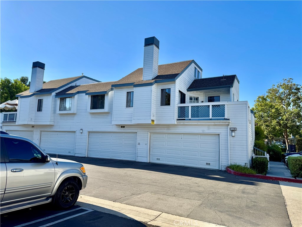 109 Fallingstar, Unit 61 Irvine, CA 92614 - Photo 2 of 34 a front view of a house with parking space