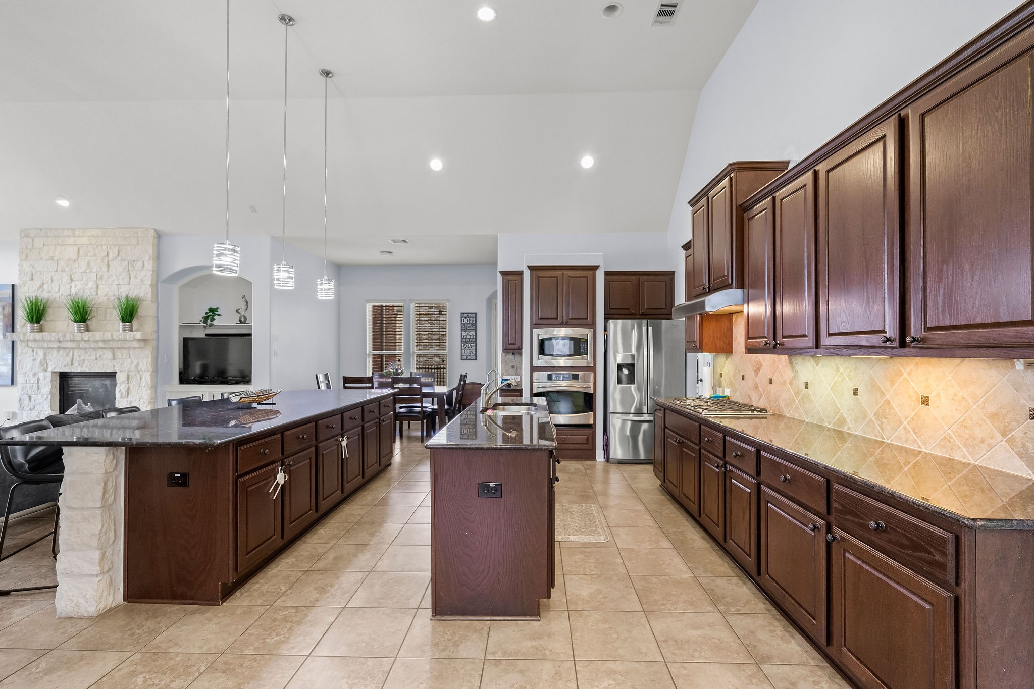 31114 Lakeview Bend Lane Spring, TX 77386 - Photo 17 of 41 a large kitchen with stainless steel appliances kitchen island granite countertop wooden cabinets a sink dishwasher a stove and a refrigerator
