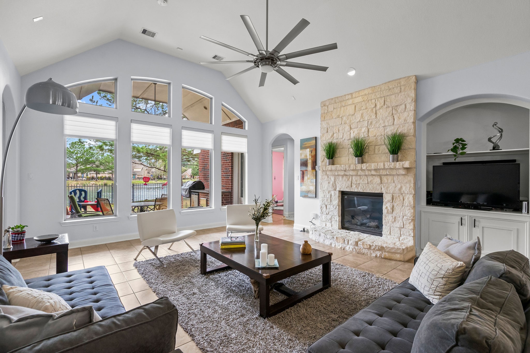 31114 Lakeview Bend Lane Spring, TX 77386 - Photo 21 of 41 a living room with furniture a flat screen tv and a fireplace