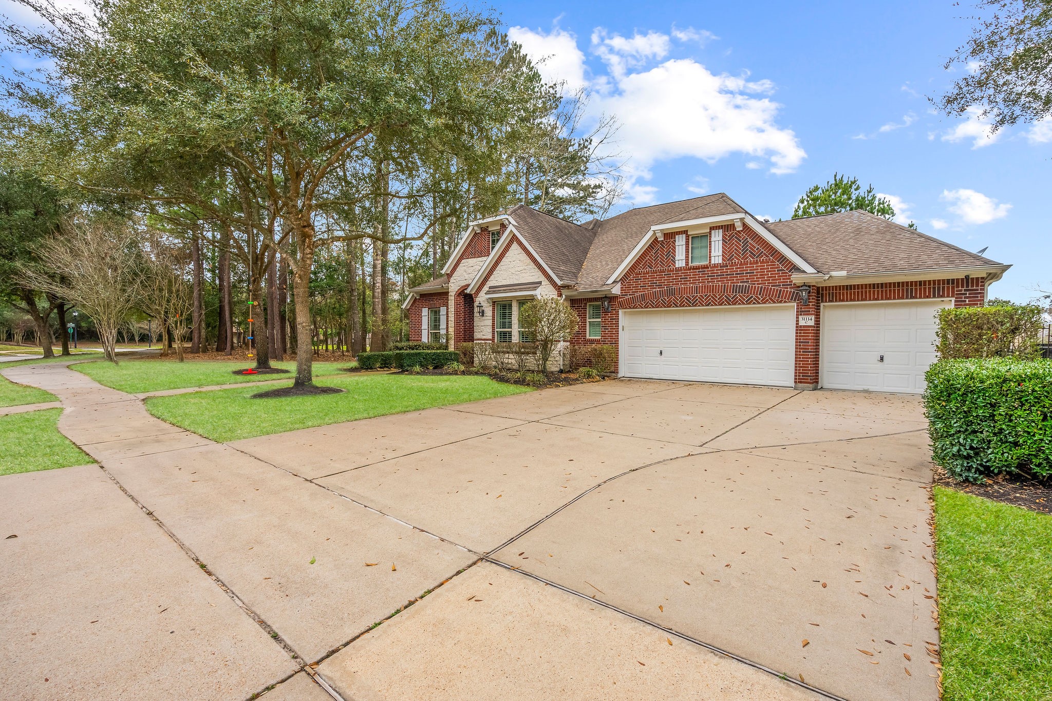 31114 Lakeview Bend Lane Spring, TX 77386 - Photo 4 of 41 a front view of a house with a yard and garage