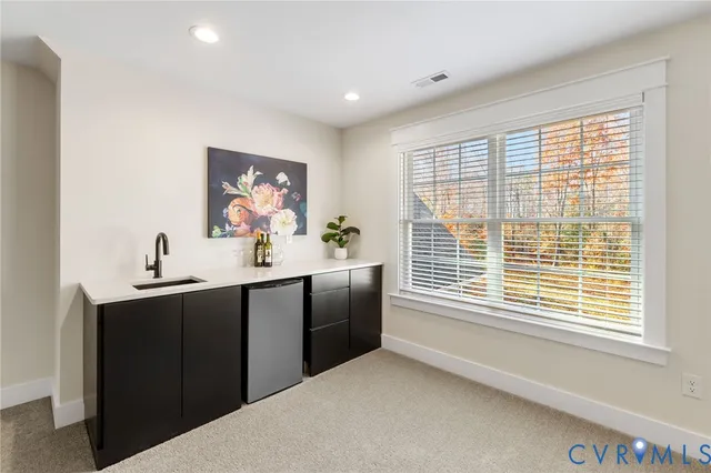 a kitchen with a sink cabinets and window
