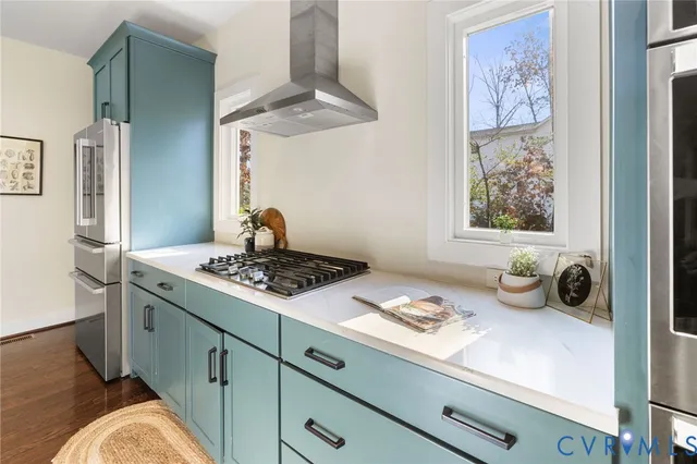 a kitchen with a stove and a window