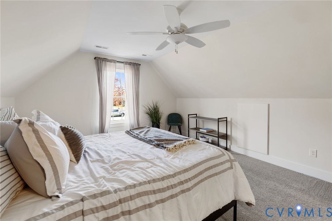9461 Wickham Crossing Way Ashland, VA 23005 - Photo 22 of 30 a bedroom with a bed and a chandelier