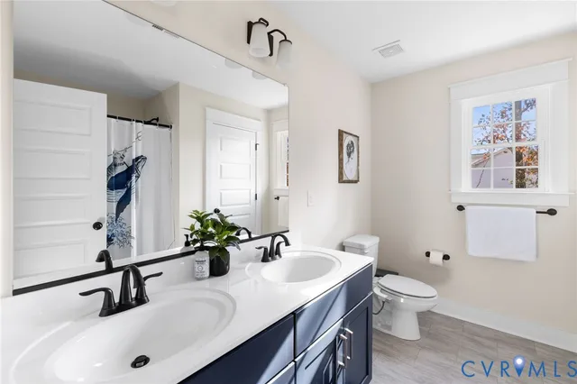 a bathroom with a sink a toilet and a mirror