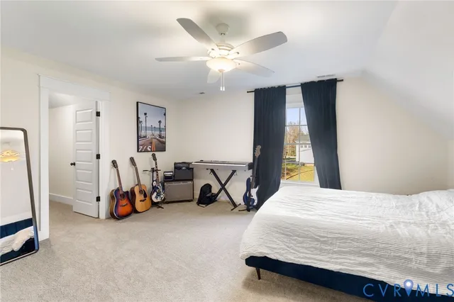a bedroom with a bed a couch and a chandelier