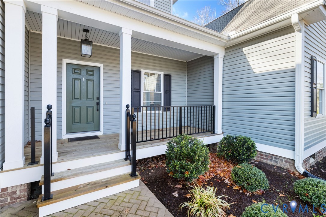 9461 Wickham Crossing Way Ashland, VA 23005 - Photo 29 of 30 a view of a porch with a flower garden