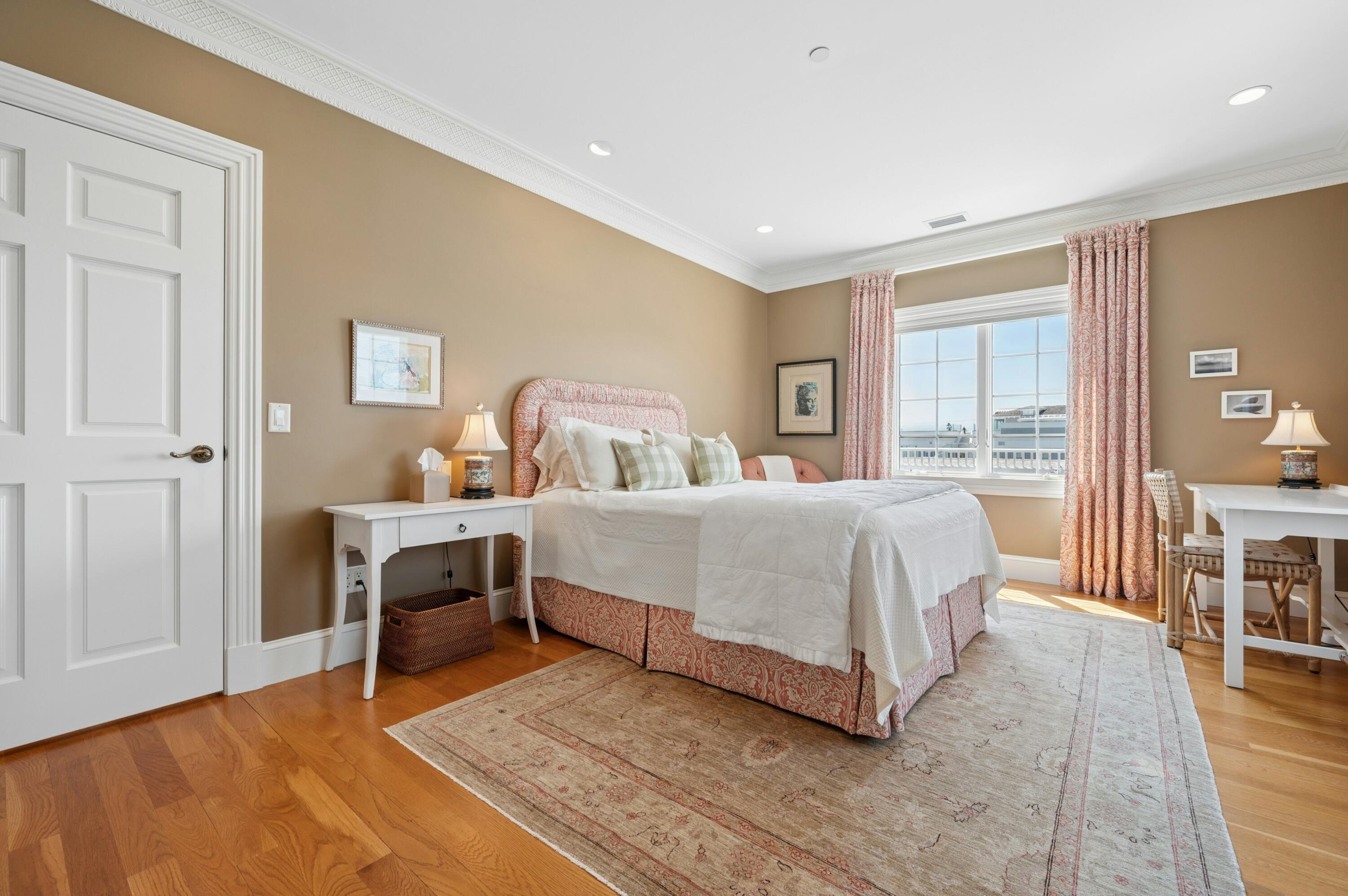 23 Snow Inn Road, Unit 7 Harwich Port, MA 02646 - Photo 23 of 37 a bedroom with a bed and a table with wooden floor