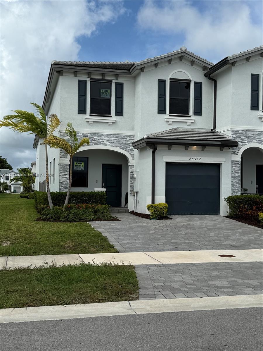 28532 Southwest 133rd Path Homestead, FL 33033 - Photo 1 of 18 a front view of a house with a garden