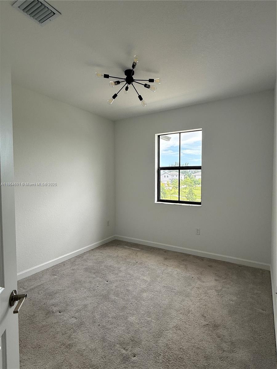 28532 Southwest 133rd Path Homestead, FL 33033 - Photo 12 of 18 an empty room with windows and ceiling fan