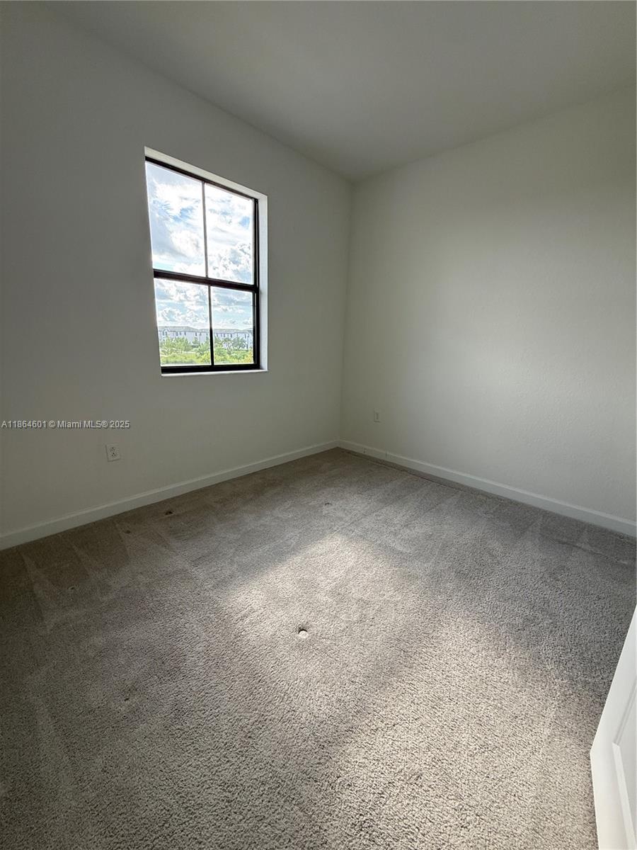 28532 Southwest 133rd Path Homestead, FL 33033 - Photo 13 of 18 an empty room with windows