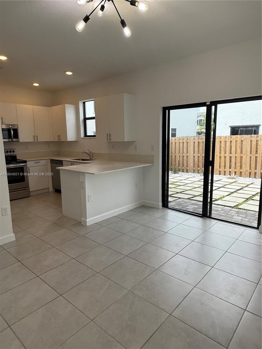 28532 Southwest 133rd Path Homestead, FL 33033 - Photo 5 of 18 a large white kitchen with a large window and kitchen view