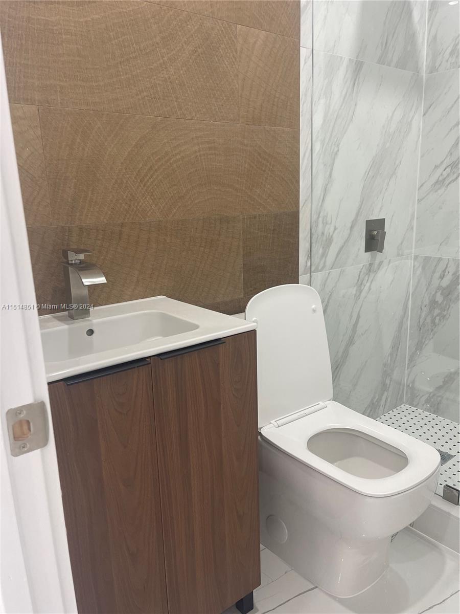 516 Southwest 66th Avenue Miami, FL 33144 - Photo 16 of 27 a white toilet sitting next to a bathroom sink