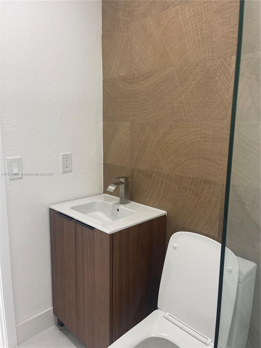 516 Southwest 66th Avenue Miami, FL 33144 - Photo 17 of 27 a bathroom with a sink a toilet and mirror