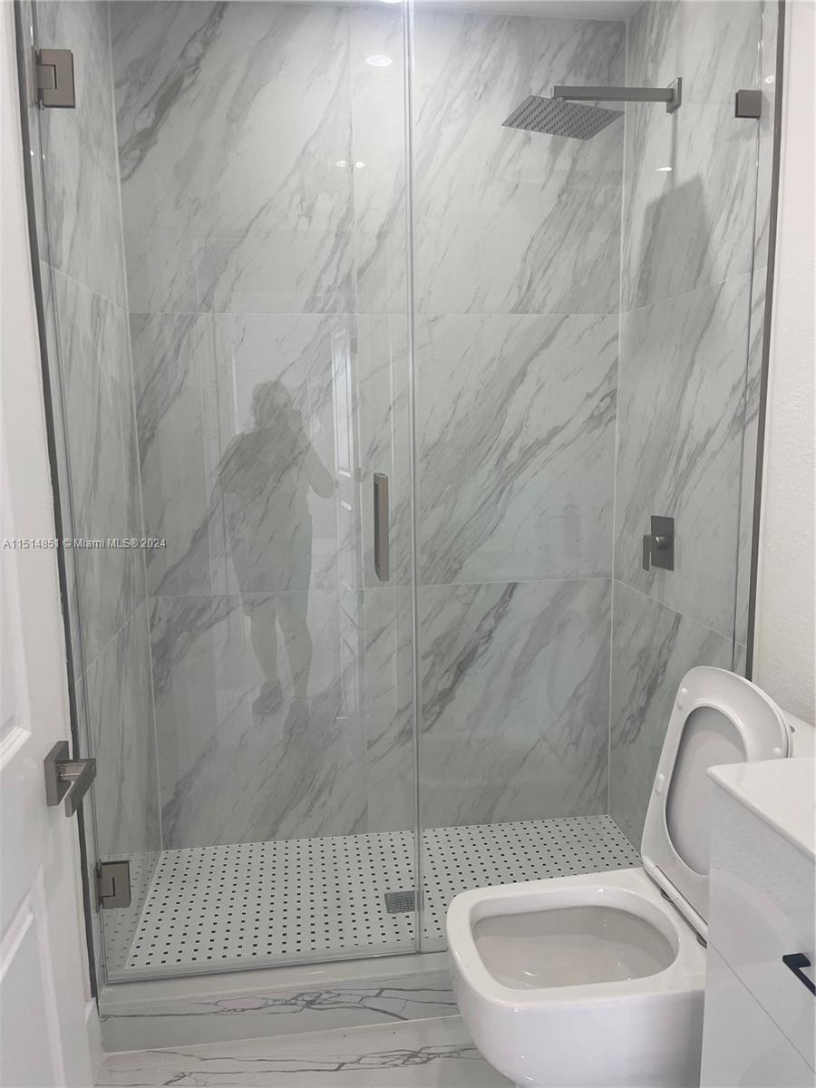 516 Southwest 66th Avenue Miami, FL 33144 - Photo 23 of 27 a bathroom with a toilet sink and shower
