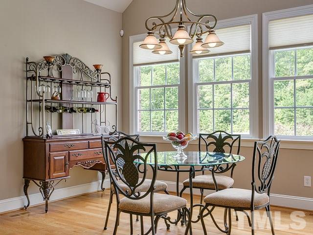 1378 Bowen Road Rougemont, NC 27572 - Photo 14 of 25 a dining room with furniture a chandelier and wooden floor