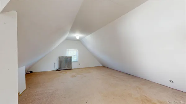 an empty room with a empty space and windows