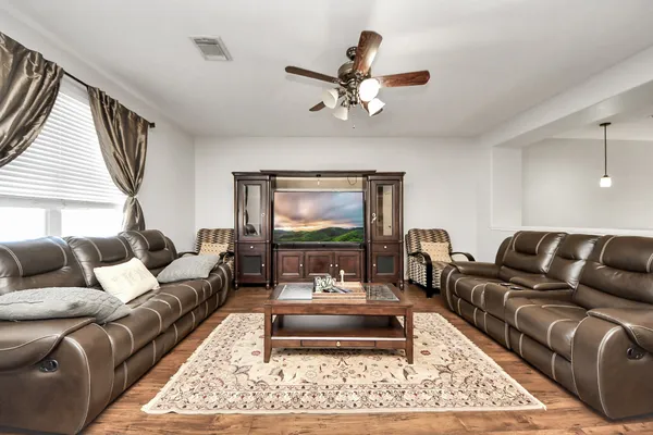 a living room with furniture a rug and a window