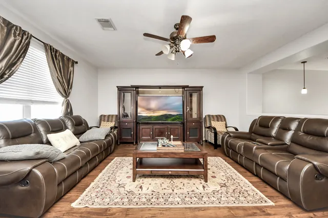 a living room with furniture a rug and a window