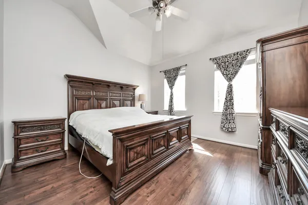 a bedroom with a bed and a chandelier