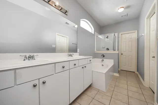 a spacious bathroom with a double vanity sink mirror and