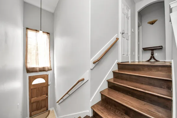 a view of staircase with wooden floor and a window