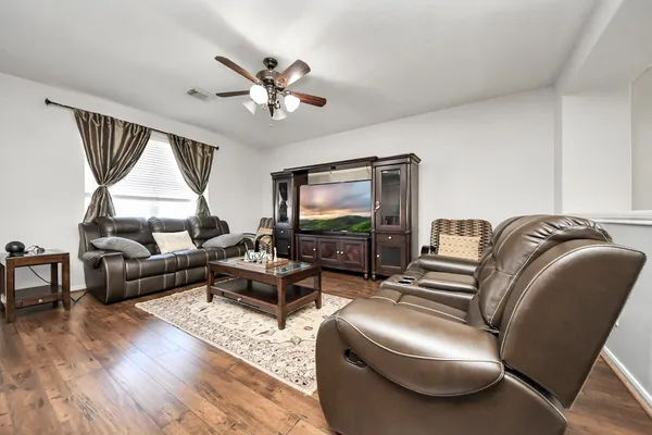 a living room with furniture and a flat screen tv