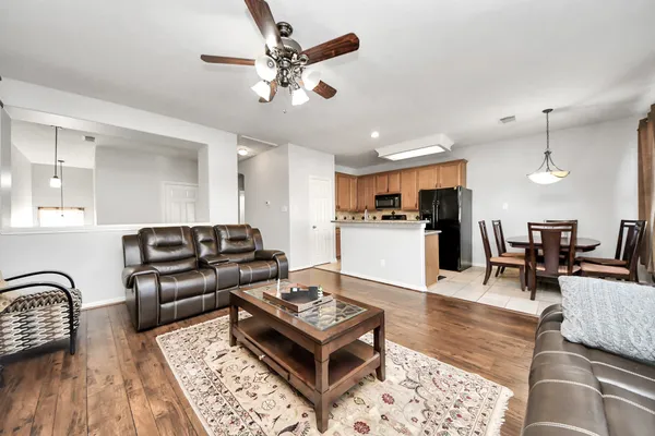 a living room with furniture and kitchen view