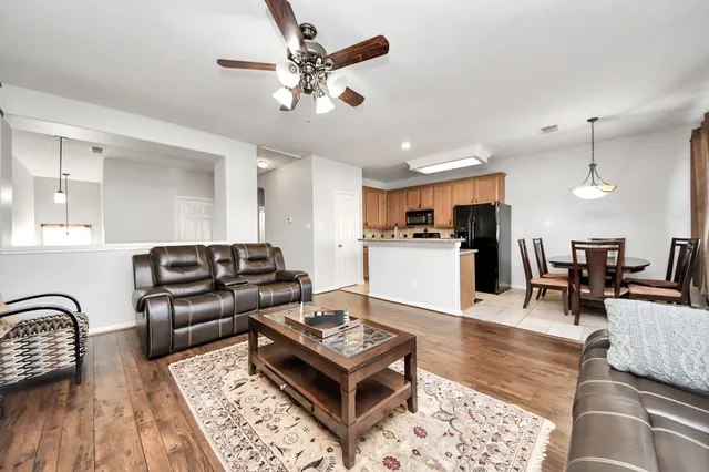 a living room with furniture and kitchen view