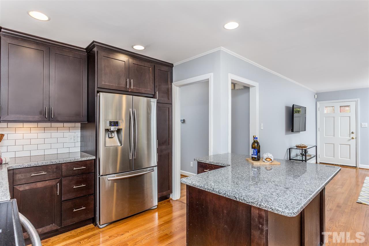 2612 Barmettler Street Raleigh, NC 27607 - Photo 11 of 24 a kitchen with stainless steel appliances granite countertop a refrigerator and a sink