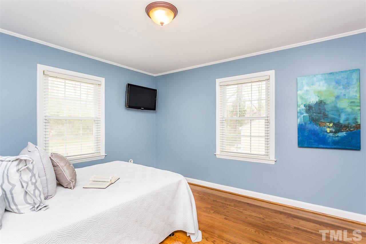 2612 Barmettler Street Raleigh, NC 27607 - Photo 13 of 24 a bedroom with a bed and a window