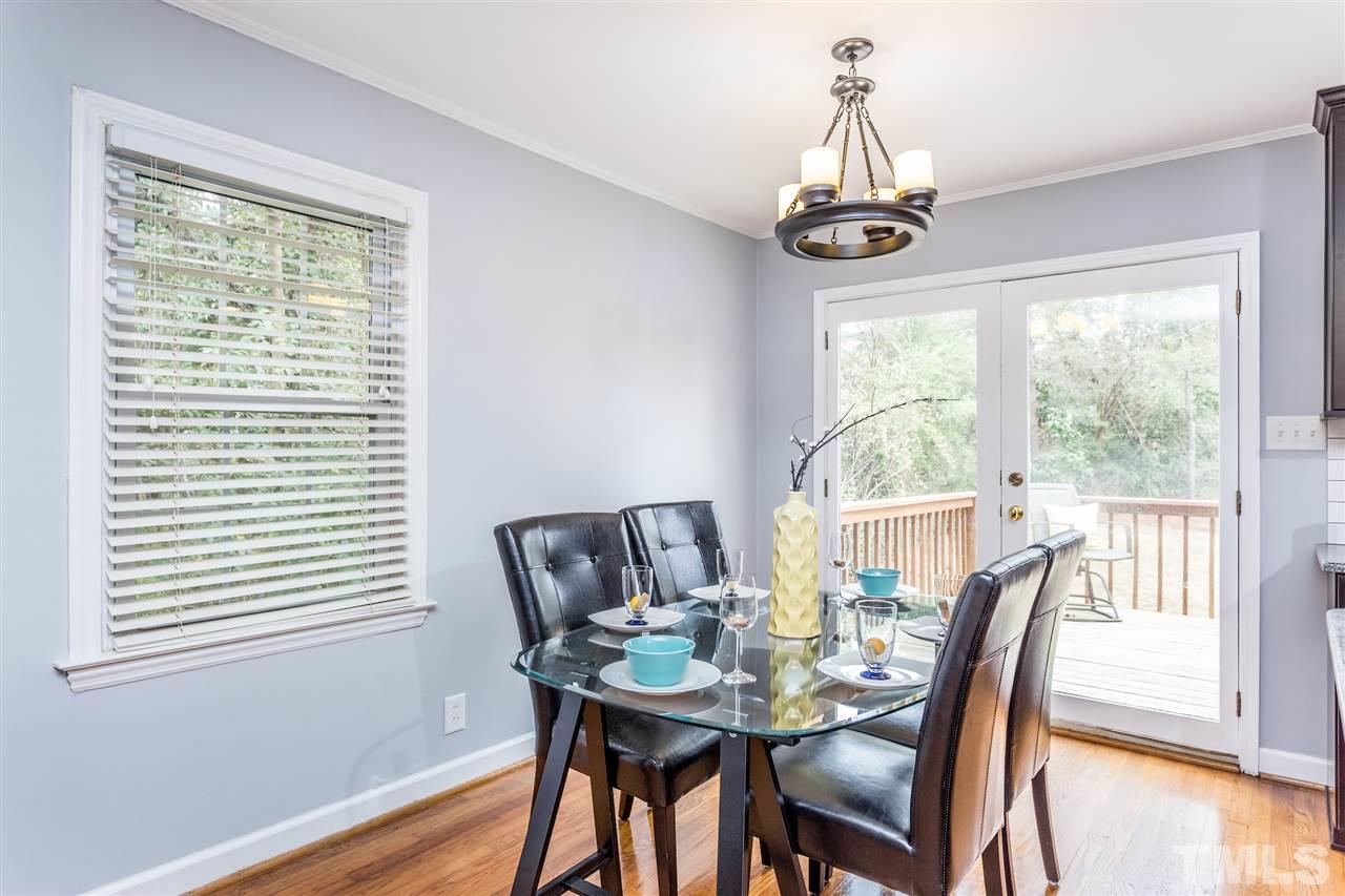 2612 Barmettler Street Raleigh, NC 27607 - Photo 5 of 24 a view of a dining room with furniture window and wooden floor