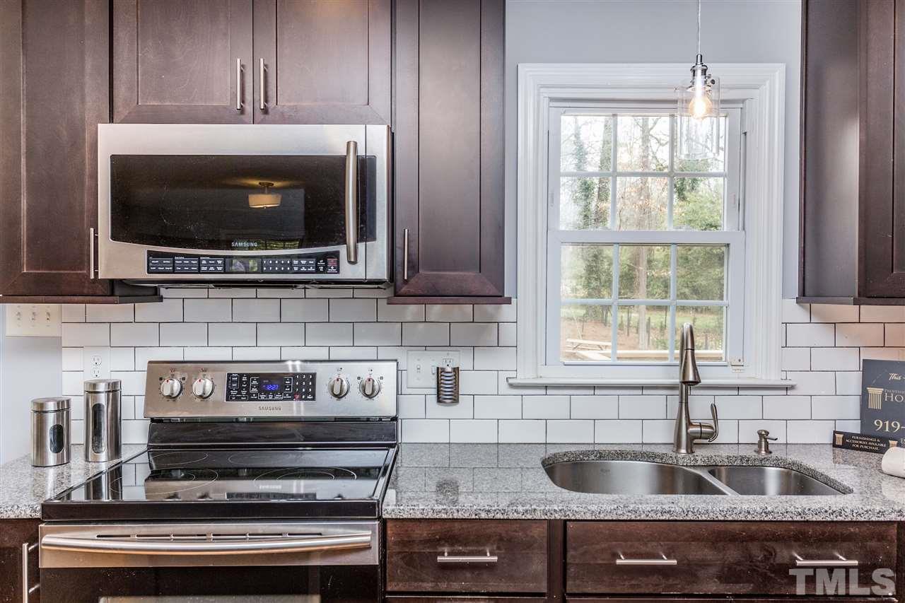 2612 Barmettler Street Raleigh, NC 27607 - Photo 9 of 24 a kitchen with a stove and a microwave
