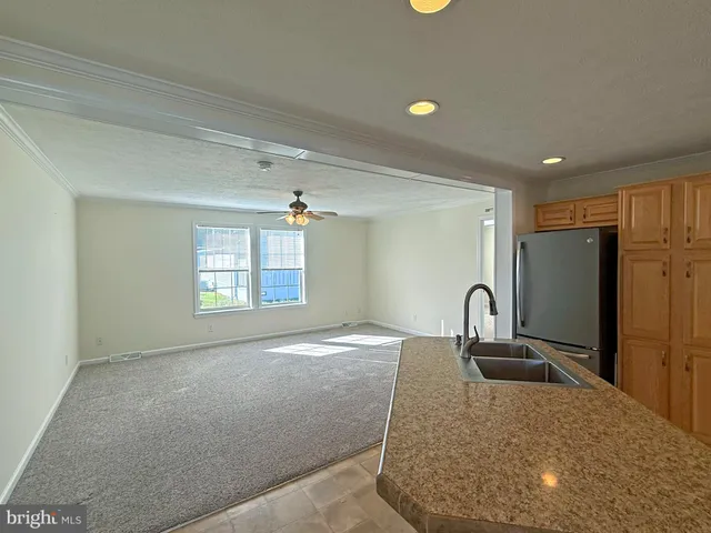 a kitchen with a refrigerator and a sink