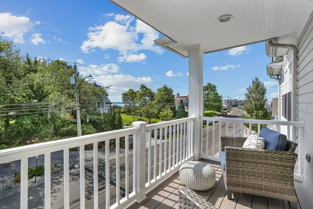 a balcony with furniture and a potted plant
