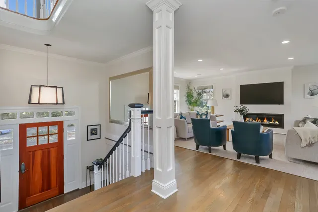 a view of a livingroom with furniture flat screen tv and staircase