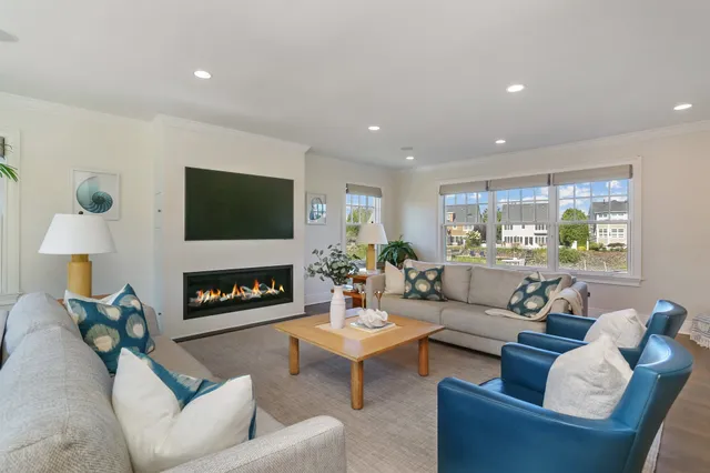 a living room with furniture a fireplace and a flat screen tv