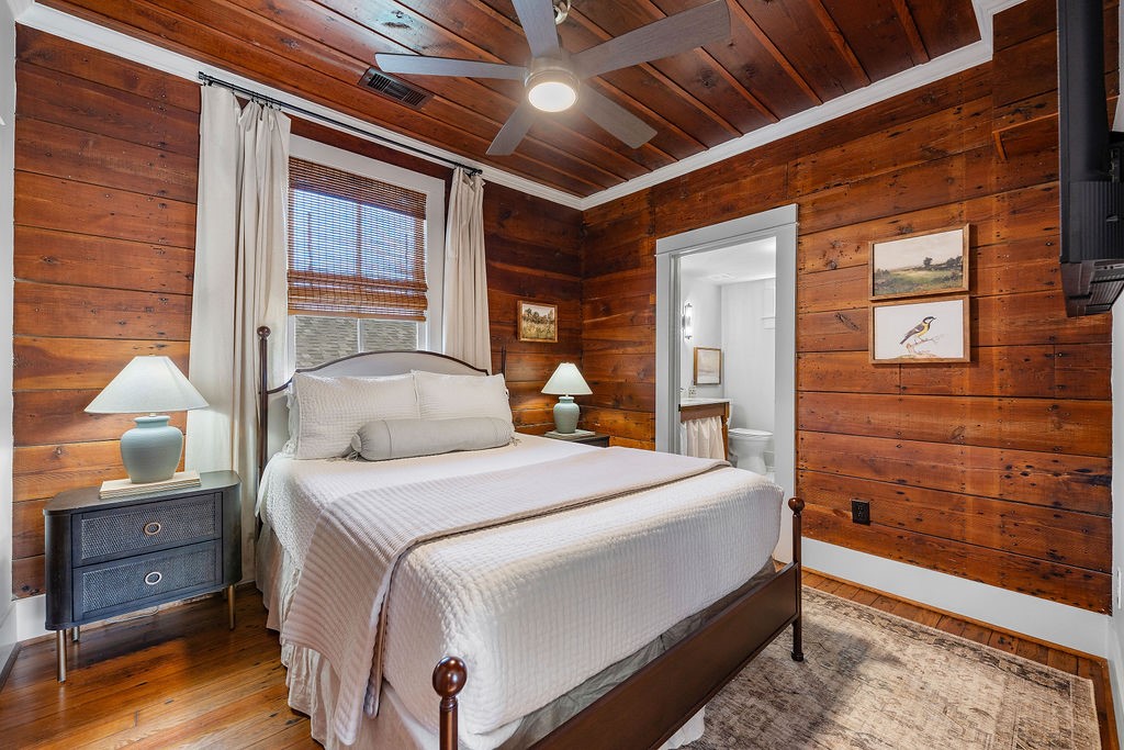 4117 Avenue R Galveston, TX 77550 - Photo 16 of 39 a bedroom with a large bed and wooden floor