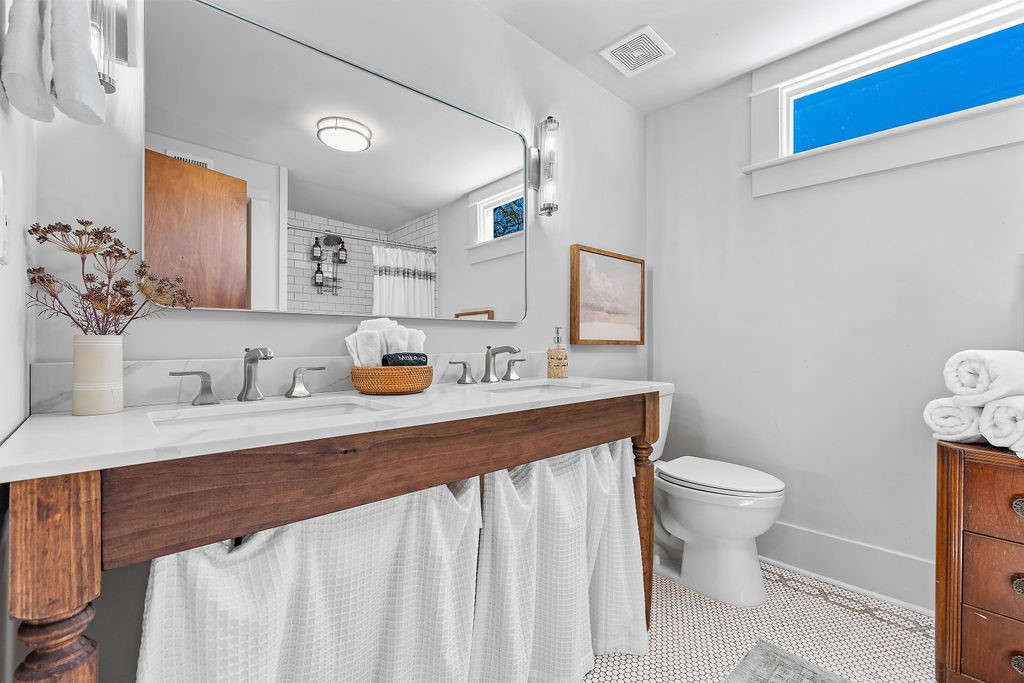 4117 Avenue R Galveston, TX 77550 - Photo 17 of 39 a bathroom with a sink toilet and mirror