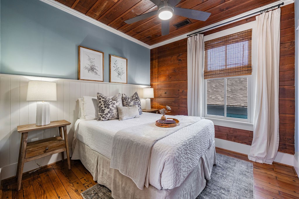 4117 Avenue R Galveston, TX 77550 - Photo 20 of 39 a bedroom with bed and wooden floor