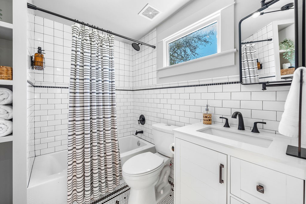 4117 Avenue R Galveston, TX 77550 - Photo 22 of 39 a bathroom with a sink toilet and shower