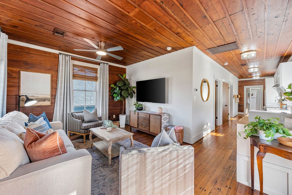 4117 Avenue R Galveston, TX 77550 - Photo 8 of 39 a living room with furniture and a flat screen tv