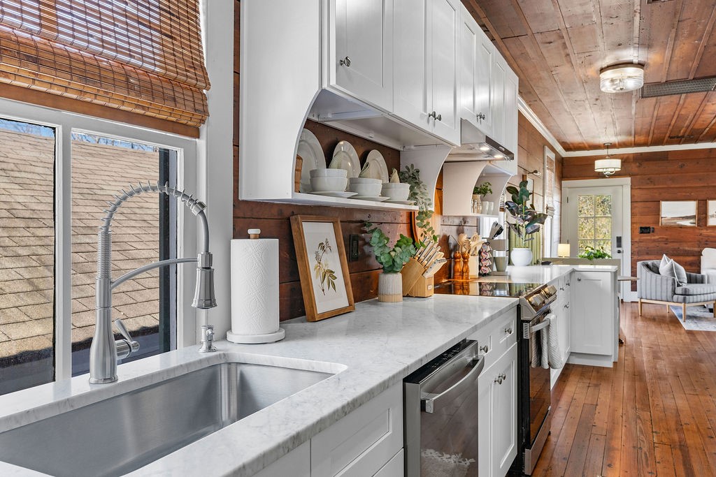 4117 Avenue R Galveston, TX 77550 - Photo 10 of 39 a kitchen with stainless steel appliances granite countertop a sink a stove and cabinets