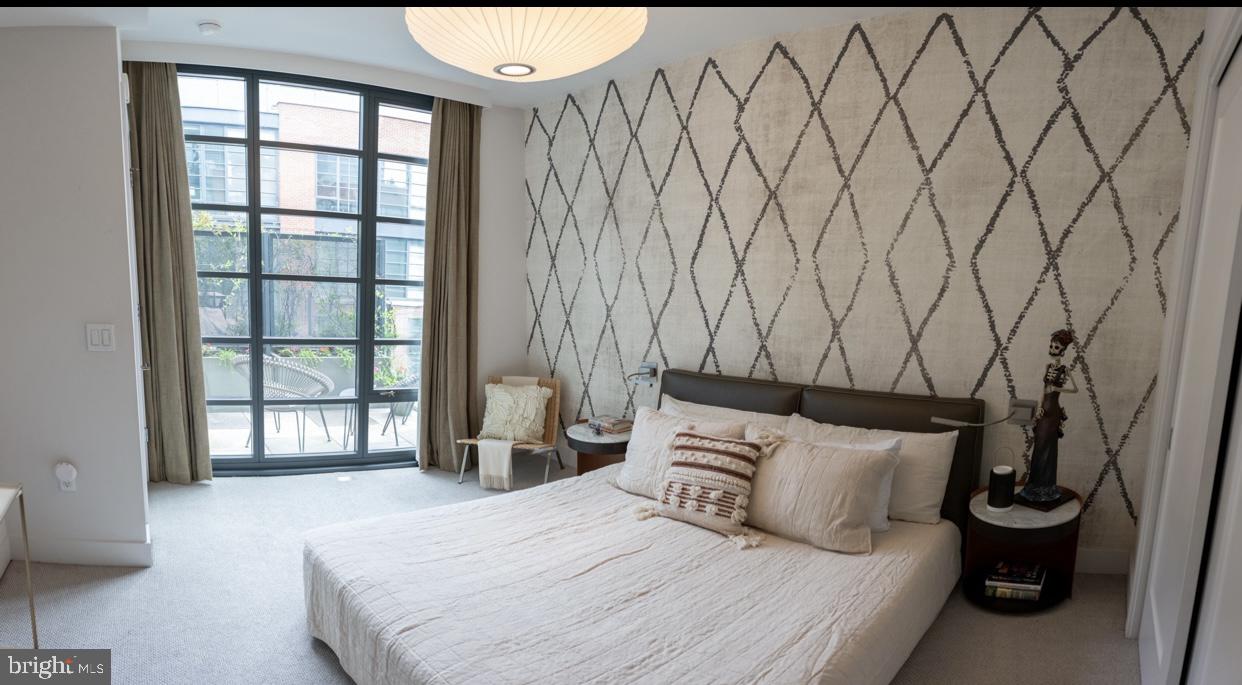 45 Sutton Square Southwest, Unit 1115 Washington, DC 20024 - Photo 8 of 14 a bedroom with a bed and a window