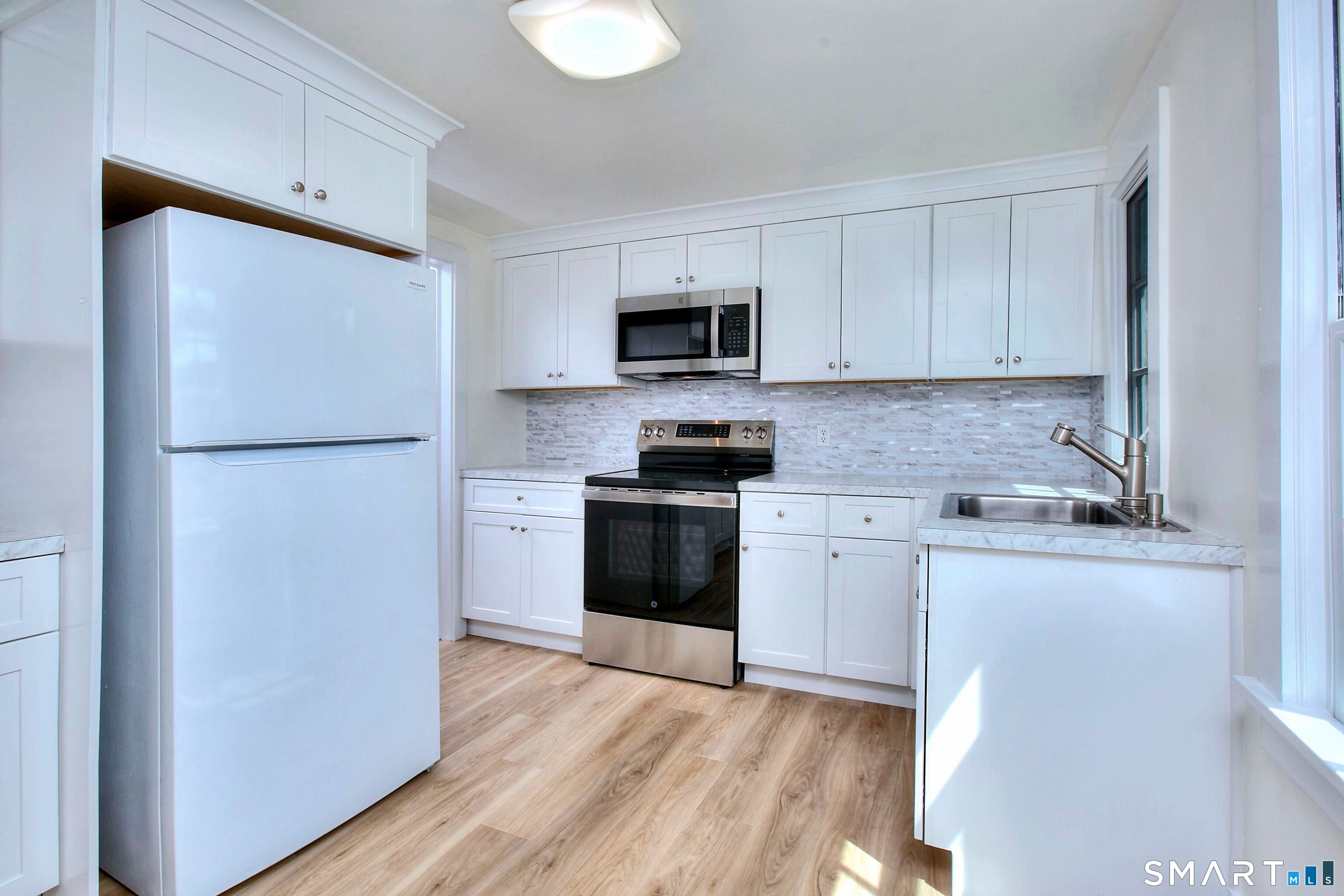 94 Honey Hill Road Wilton, CT 06897 - Photo 7 of 18 a kitchen with a refrigerator stove and microwave