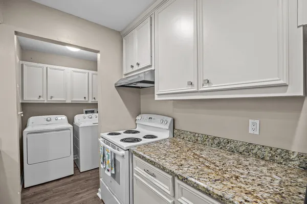 a kitchen with a stove and a refrigerator