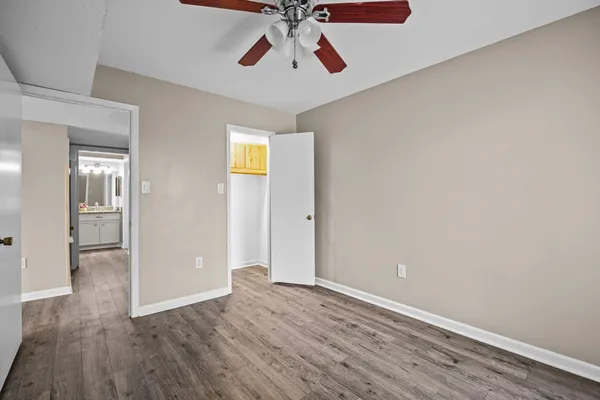 a view of empty room with wooden floor