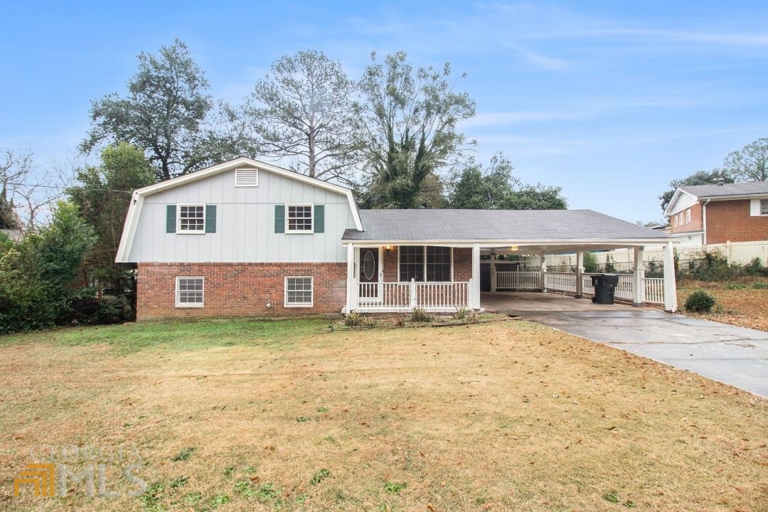 6354 Lanier Road Morrow, GA 30260 - Photo 1 of 1 a front view of a house with a garden